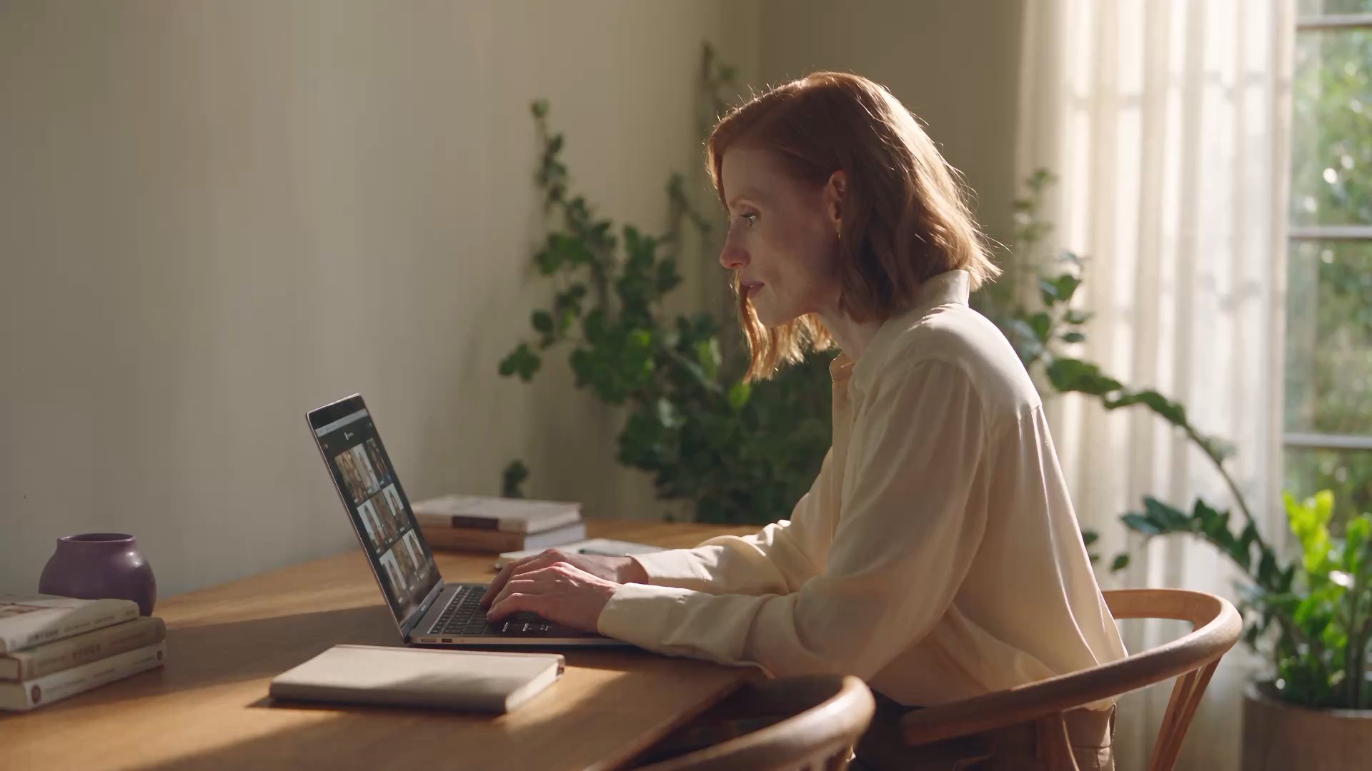 AI-generated scene of a mentor leading an online class from a sunlit home workspace.